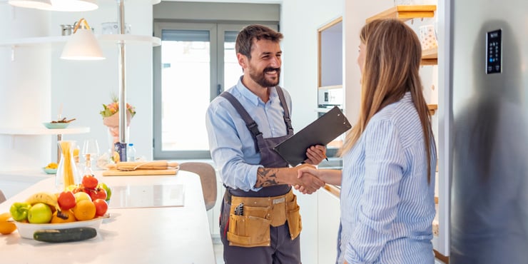Contractor meeting client in their home by shaking hands 
