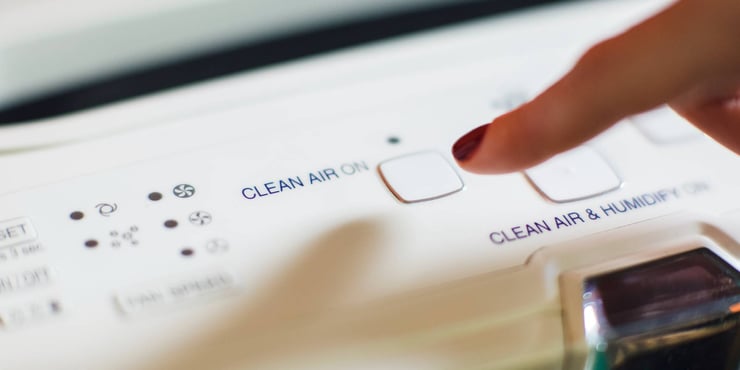Finger pressing Clean Air button. 