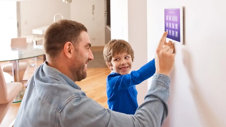 father and son changing the settings on a thermostat