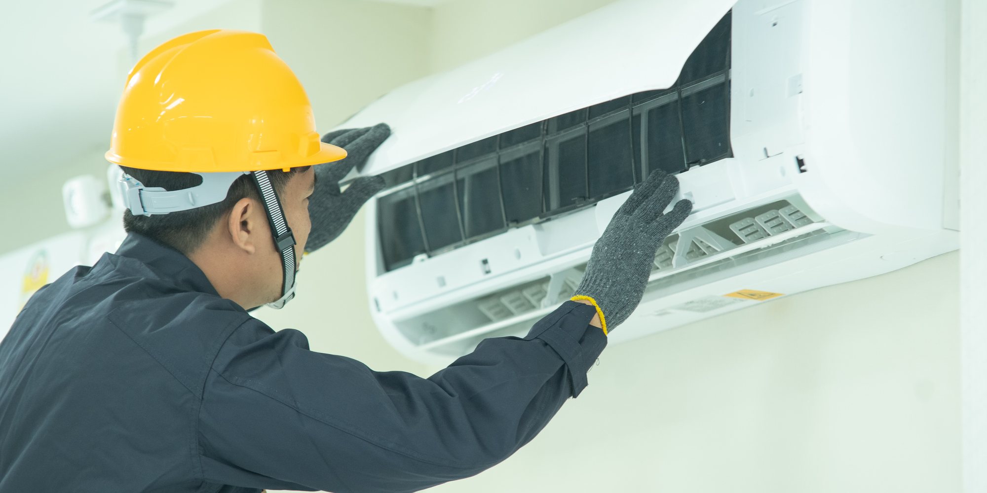 repairman fixing split ac