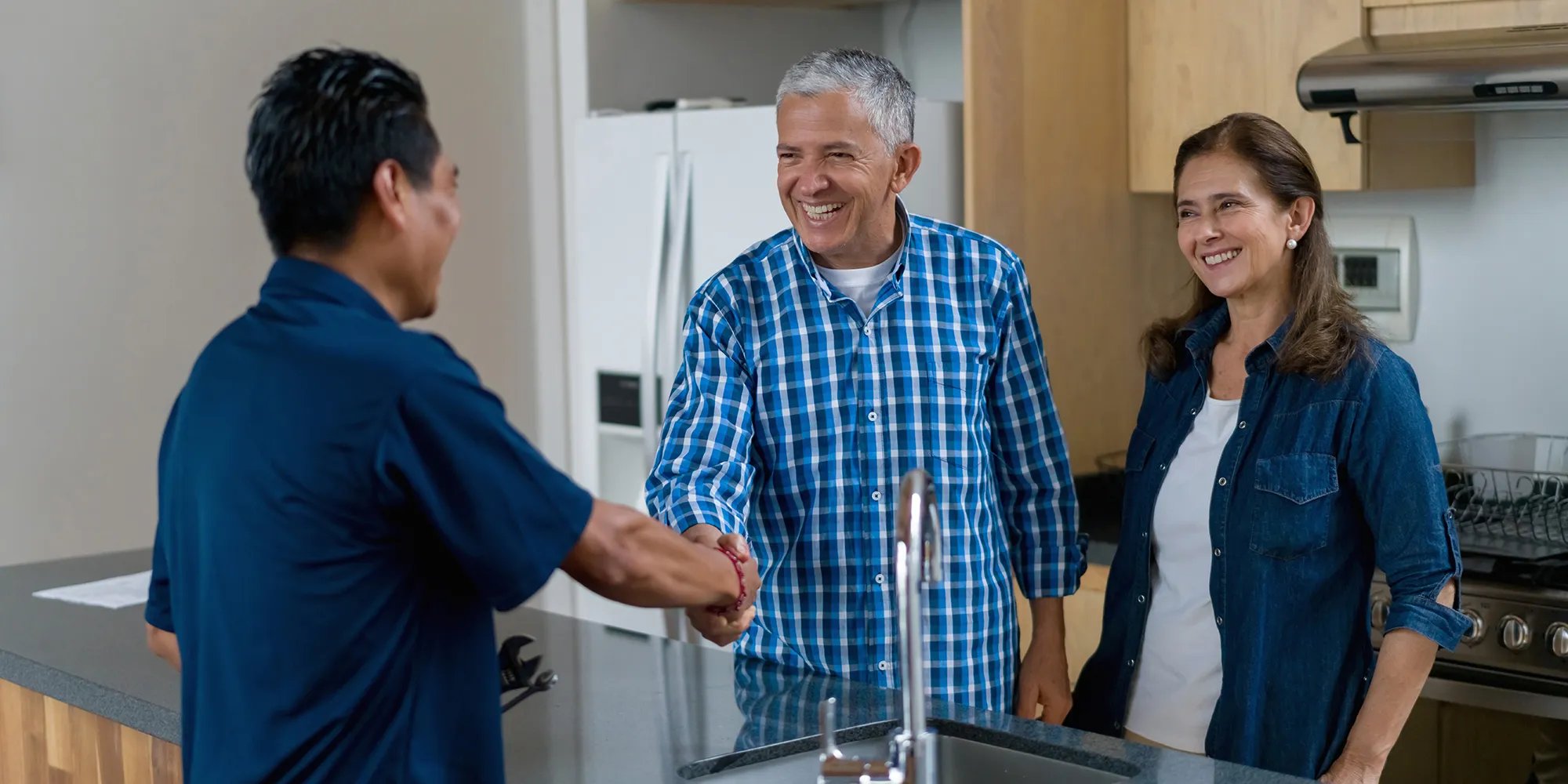 Contractor shaking hands with a customer in their home.