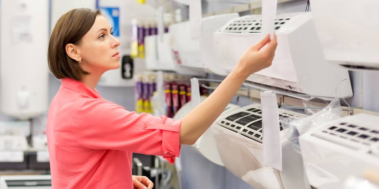 Woman observing an air conditioner