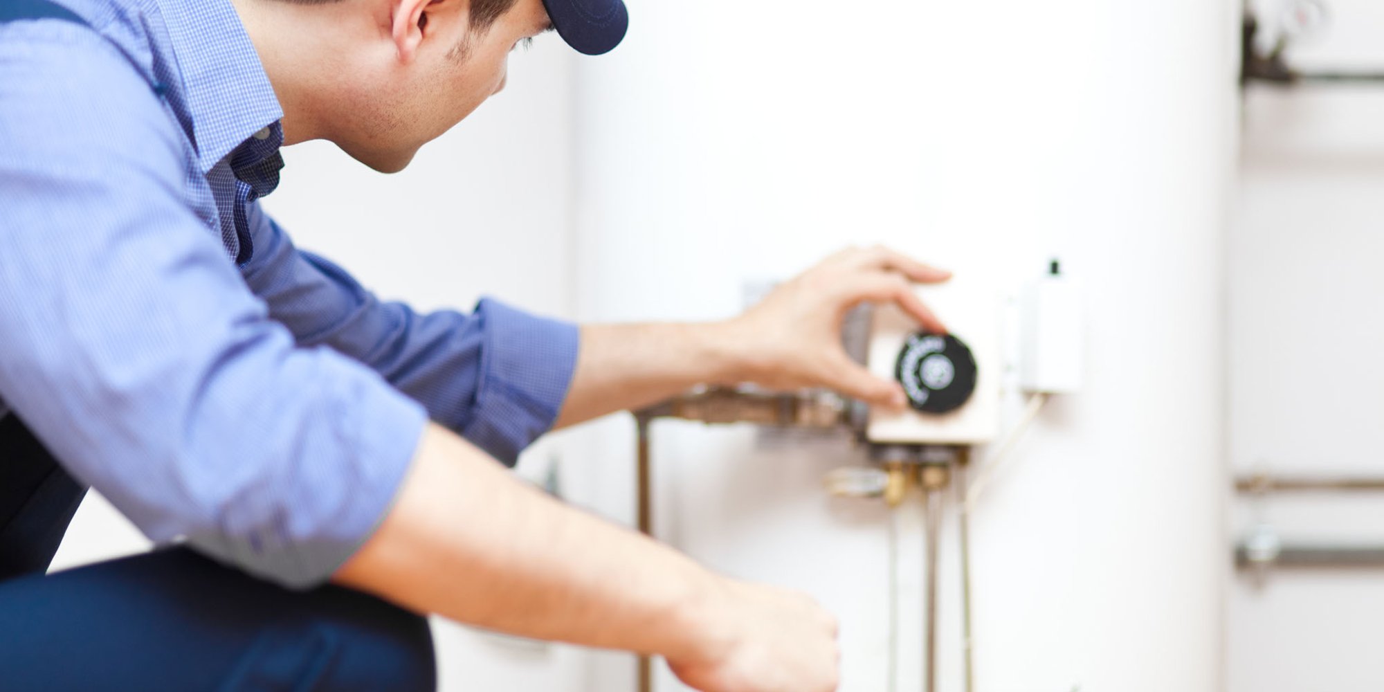 contractor adjusting boiler