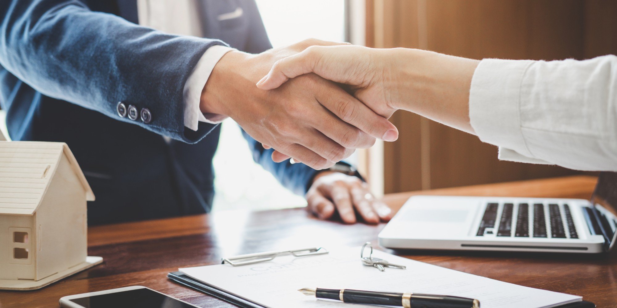 Real Estate Or Insurance Agent Shaking Hands With Client